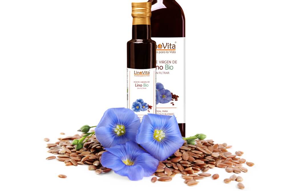 botellas de aceite linovita con semillas y la flor de lino