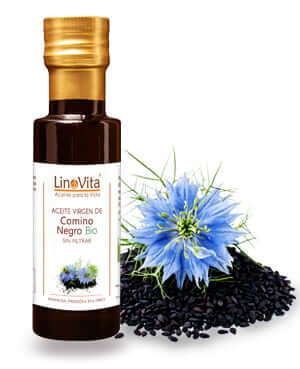 botella de aceite y flor con semillas negras en fondo de comino negro nigella sativa abesoda agenuz de marca linovita