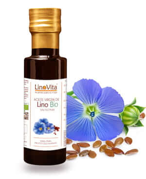 botella de aceite y flor violeta y semillas marrones en fondo de lino linaza linum de marca linovita